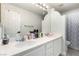 Bright bathroom featuring dual sinks, a large mirror, and a shower with curtain at 9440 Grenville Ave, Las Vegas, NV 89134