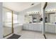 Bright bathroom with a tub, separate shower, double vanity, and tiled floors at 9440 Grenville Ave, Las Vegas, NV 89134