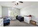 Bedroom with ceiling fan, neutral paint, carpet flooring, and natural light at 9440 Grenville Ave, Las Vegas, NV 89134