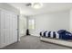 Bedroom with a twin bed, carpet floors, plantation shutters, and closet with white door at 9440 Grenville Ave, Las Vegas, NV 89134