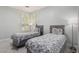 Bright bedroom featuring two twin beds, neutral decor, and plantation shutters at 9440 Grenville Ave, Las Vegas, NV 89134