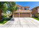 Inviting two-story home with a three-car garage and well-maintained landscaping and driveway at 9440 Grenville Ave, Las Vegas, NV 89134