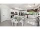 Spacious kitchen featuring white cabinets, stainless steel appliances, and a central island with bar seating at 9440 Grenville Ave, Las Vegas, NV 89134