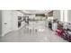 Spacious kitchen boasts white cabinets, granite counters, and a large island perfect for Gathering gatherings at 9440 Grenville Ave, Las Vegas, NV 89134