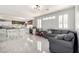 Open-concept living room and kitchen area featuring tile floors and lots of natural light at 9440 Grenville Ave, Las Vegas, NV 89134