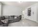 Spacious living room with a gray sectional sofa and built-in white shelving at 9440 Grenville Ave, Las Vegas, NV 89134