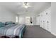 Spacious main bedroom with carpet flooring, a ceiling fan, and an attached bathroom at 9440 Grenville Ave, Las Vegas, NV 89134