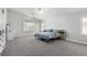 Bright main bedroom featuring a ceiling fan, shutters, carpeted floor, and ample closet space at 9440 Grenville Ave, Las Vegas, NV 89134