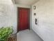 Red front door with gray trim and exterior lighting offering a secure entrance to your new home at 950 Seven Hills Dr # 217, Henderson, NV 89052