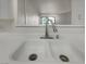Kitchen sink with white countertop and view to adjacent room at 950 Seven Hills Dr # 217, Henderson, NV 89052