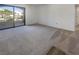Spacious carpeted living room with sliding glass door and access to outdoor balcony with lots of natural light at 950 Seven Hills Dr # 217, Henderson, NV 89052