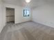 Bright main bedroom with window, spacious closet, and neutral carpet, ready for your personal touches at 950 Seven Hills Dr # 217, Henderson, NV 89052