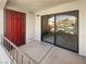 Private patio with sliding glass door, red front door, and metal railings providing outdoor retreat at 950 Seven Hills Dr # 217, Henderson, NV 89052