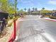 Gated community entrance with lush landscaping, trees, and manicured shrubbery leading into the neighborhood at 950 Seven Hills Dr # 217, Henderson, NV 89052