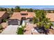 Aerial view of home with manicured front yard, driveway, and desert landscaping at 9520 Sundial Dr, Las Vegas, NV 89134