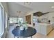 Open concept kitchen features an eat-in area, stainless appliances and modern white cabinets at 9520 Sundial Dr, Las Vegas, NV 89134