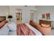 Spacious main bedroom with elegant furnishings, neutral tones, and views into the en-suite bathroom at 9520 Sundial Dr, Las Vegas, NV 89134