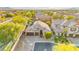 Stunning aerial view of a home featuring a 3-car garage, and landscaped yard at 9685 Stonily Ln, Las Vegas, NV 89178