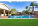 Lush backyard with a sparkling pool, gazebo, and manicured lawn, creating an outdoor oasis at 9685 Stonily Ln, Las Vegas, NV 89178