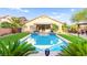 Stunning backyard features a pristine pool, covered patio, and mature landscaping for private enjoyment at 9685 Stonily Ln, Las Vegas, NV 89178
