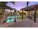 Relaxing backyard with a pool, spa, covered patio, and lush landscaping, perfect for outdoor living at 9685 Stonily Ln, Las Vegas, NV 89178