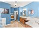 Blue bathroom with double sinks, tile accents, and a bathtub/shower combination with eye-catching design at 9685 Stonily Ln, Las Vegas, NV 89178