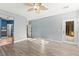 Bright bedroom featuring neutral paint, wood flooring, a ceiling fan, and a glass door leading to the backyard at 9685 Stonily Ln, Las Vegas, NV 89178