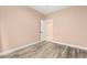 Bedroom featuring wood-look floors, neutral paint, and an open closet with door at 9685 Stonily Ln, Las Vegas, NV 89178