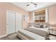 Virtually staged bedroom with neutral paint, wood-look floors, closet, and a window with curtains at 9685 Stonily Ln, Las Vegas, NV 89178