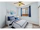 Blue bedroom featuring white furnishings, hardwood floors, a ceiling fan, and a window with dark drapes at 9685 Stonily Ln, Las Vegas, NV 89178
