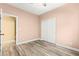 Bedroom featuring wood-look floors, neutral paint, and an open closet with double doors at 9685 Stonily Ln, Las Vegas, NV 89178