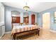 Cozy dining room with a wooden bench and table under a decorative light fixture and beautiful archways at 9685 Stonily Ln, Las Vegas, NV 89178