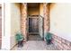 Charming gated entrance with stone pillars, wrought iron gate, and manicured plants, offering a welcoming arrival at 9685 Stonily Ln, Las Vegas, NV 89178