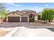 Stunning two-story home with brick driveway, three-car garage, and manicured landscaping, showcasing curb appeal at 9685 Stonily Ln, Las Vegas, NV 89178