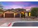 Beautiful home featuring a three-car garage, stone accents, and well-manicured landscaping at 9685 Stonily Ln, Las Vegas, NV 89178