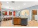 Kitchen island and sink area with tile floors and seating at 9685 Stonily Ln, Las Vegas, NV 89178