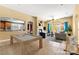 Open-concept living space with pool table, fireplace, and seamless flow to the kitchen and outdoor area at 9685 Stonily Ln, Las Vegas, NV 89178