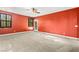 Spacious living room with carpeted floors, a ceiling fan, and access to a rear exterior door at 9685 Stonily Ln, Las Vegas, NV 89178