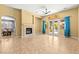 Bright living room with fireplace, tile floors, ceiling fan and access to outdoor pool area at 9685 Stonily Ln, Las Vegas, NV 89178