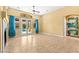 Bright and airy living room with tile flooring, large windows, and backyard access, perfect for indoor-outdoor living at 9685 Stonily Ln, Las Vegas, NV 89178