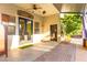 Covered patio featuring a ceiling fan and brick flooring, extending to a well-maintained backyard at 9685 Stonily Ln, Las Vegas, NV 89178