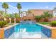 Beautiful backyard pool with vibrant blue tile accents and lush landscaping; perfect for relaxation at 9685 Stonily Ln, Las Vegas, NV 89178