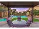 Cozy outdoor dining area featuring view of the pool with relaxing scene at 9685 Stonily Ln, Las Vegas, NV 89178