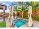Luxurious backyard spa with a decorative cabana and lush landscaping, offering a tranquil escape at 9685 Stonily Ln, Las Vegas, NV 89178