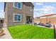 Well kept backyard featuring lush green grass, a cozy patio area with outdoor seating, and meticulously maintained landscaping at 9743 Mojave Mountain St, Las Vegas, NV 89166