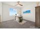 This staged bedroom features a work desk, a painting of a beach, and a ceiling fan at 9743 Mojave Mountain St, Las Vegas, NV 89166