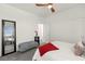 Bright bedroom with a ceiling fan, soft carpet, a full-length mirror, and natural light for a relaxing home at 9743 Mojave Mountain St, Las Vegas, NV 89166