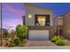 Modern two-story home with a front-facing garage and a second-story balcony with seating at 9743 Mojave Mountain St, Las Vegas, NV 89166