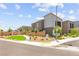 Modern two-story home exterior featuring manicured landscaping and a community green space at 9743 Mojave Mountain St, Las Vegas, NV 89166