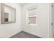 Cozy hallway featuring wall mirror, window with blinds and neutral colors at 9743 Mojave Mountain St, Las Vegas, NV 89166